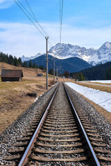 The railway road on the background of Alps mountains in the snow in Klais, Krün, Bayern