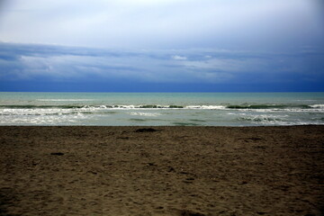Fototapeta na wymiar Layered horizontal view of the beach and stormy sea