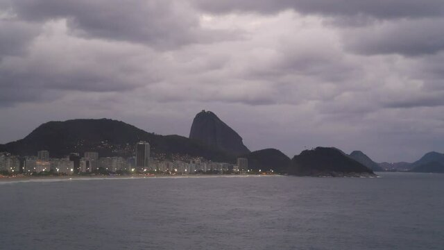 Copacabana beach, Rio, by dusk, with view to the Sugar Loaf mountain

