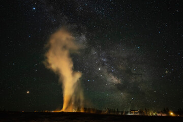 USA, Wyoming, Yellowstone National Park. Milky Way and erupting Old Faithful Geyser.