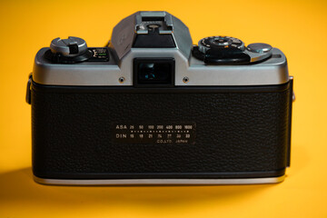 old vintage hipster camera in a color background 