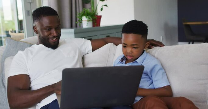 African american father and son using a laptop together