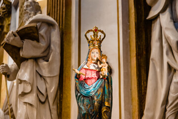 Fototapeta na wymiar Painted wood carving of the Virgin of the Forsaken, invocation of the Virgin Mary, inside a Valencian church.