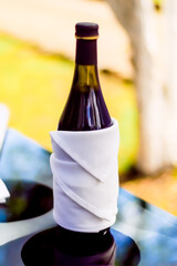 WINE BOTTLE COVERED WITH WHITE CLOTH