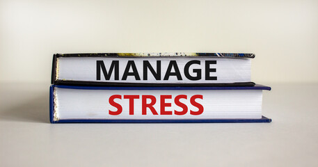 Manage stress and be health symbol. Books with words 'manage stress'. Beautiful white background. Psychological, business and manage stress concept. Copy space.