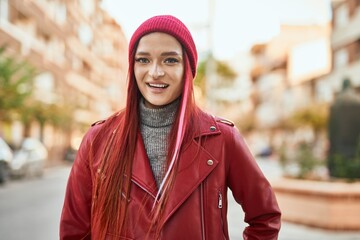 Young caucasian girl smiling happy standing at the city.