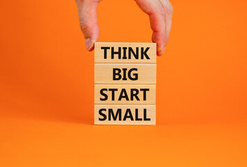 Think big start small symbol. Concept words 'Think big start small' on wooden blocks on a beautiful...