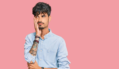 Young hispanic man wearing casual clothes thinking looking tired and bored with depression problems with crossed arms.