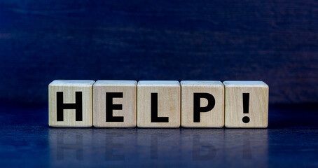 Support and help symbol. Wooden cubes with the word 'help'. Business, psychology, support and help concept. Beautiful black background, copy space.