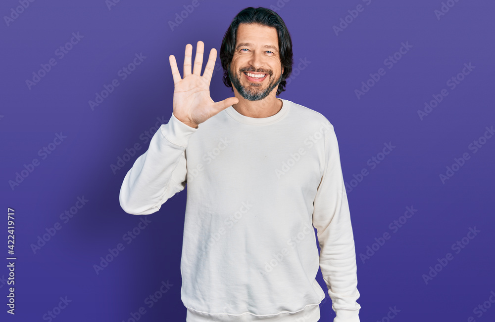 Sticker Middle age caucasian man wearing casual clothes showing and pointing up with fingers number five while smiling confident and happy.