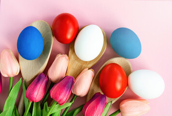 Fototapeta na wymiar Happy Easter holiday background, Easter eggs blue, white, red colors on pink background