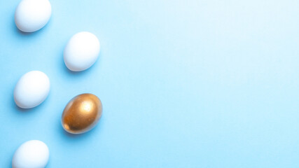 Easter eggs background. Golden, white colour egg on pastel blue background in Happy Easter decoration. Foil minimalist egg design, modern top view template.