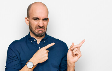 Young hispanic man wearing casual clothes pointing aside worried and nervous with both hands, concerned and surprised expression