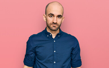 Young hispanic man wearing casual clothes relaxed with serious expression on face. simple and natural looking at the camera.