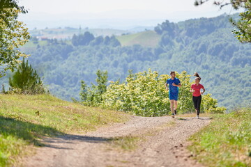 couple enjoying in a healthy lifestyle while jogging on a country road