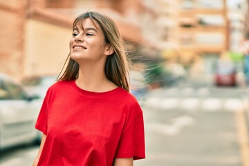 Caucasian teenager girl smiling happy standing at the city.