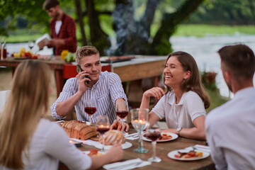 friends having picnic french dinner party outdoor during summer holiday