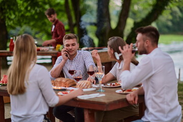 friends having picnic french dinner party outdoor during summer holiday