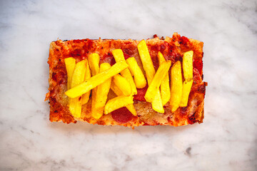 Pizza slice with tomato sauce mozzarella cheese salami and french fries