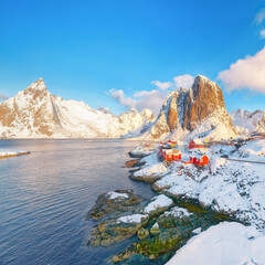 Picturesque winter view on Hamnoy village and Festhaeltinden mountain on background.