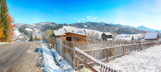 Fantastic winter landscape with wooden houses in snowy mountains.