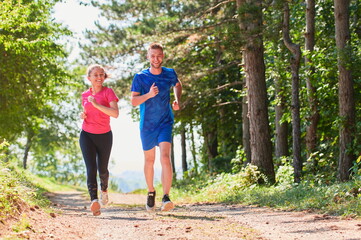 couple enjoying in a healthy lifestyle while jogging on a country road