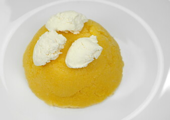 Polenta with Cheese and Sour Cream in a Plate isolated on white background.