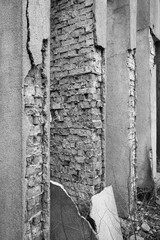 Fragment of the structure of the columns of a red brick building in a city built in the USSR. The plaster has collapsed and needs to be repaired. Photographed in Ukraine, Kiev.