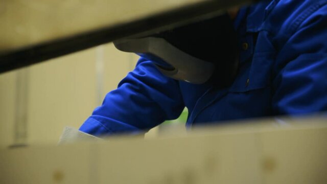 Welder with protective mask at work