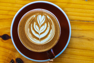 a cup of coffee on a wooden table
