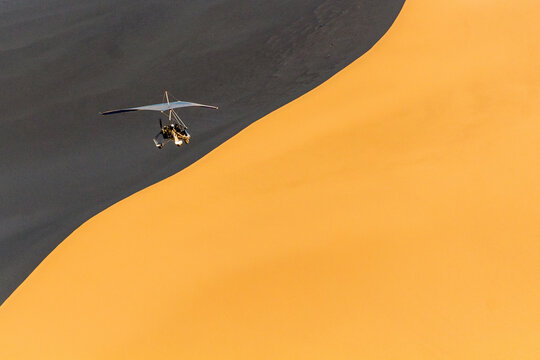 Rogalo flying over Singing Sands Dune near Dunhuang, Gansu Province, China