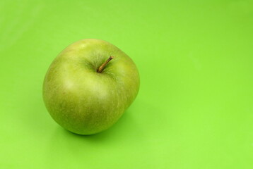 Beautiful natural organic green apple  on a green background.