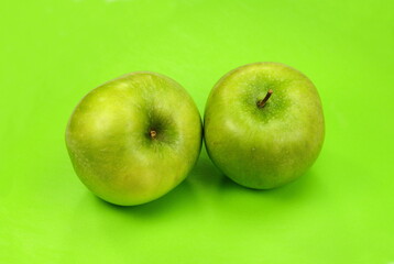 Beautiful natural organic green apple  on a green background.