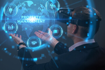 Business, Technology, Internet and network concept. Young businessman working on a virtual screen of the future and sees the inscription: Property management