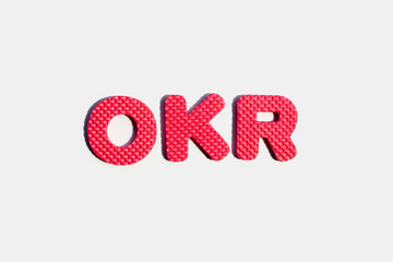 OKR puzzle alphabets on white.