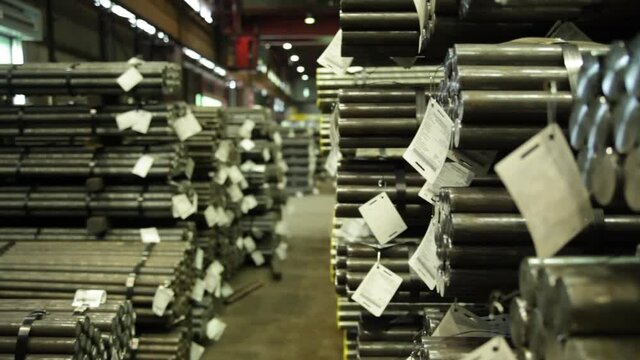 Stacked steel tubes in a warehouse