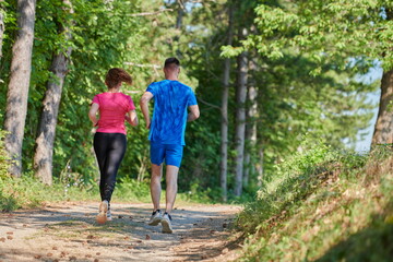 Obraz premium couple enjoying in a healthy lifestyle while jogging on a country road