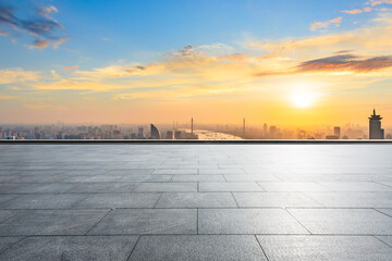 Empty square and city skyline at sunset in Shanghai.