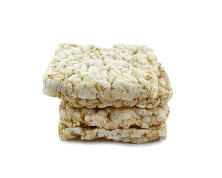 Puffed rice cakes isolated on white. Stack of puffed whole grain crispbread isolated on white.