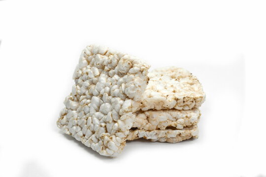 Puffed rice cakes isolated on white. Stack of puffed whole grain crispbread isolated on white.