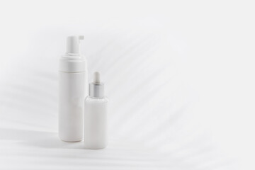 Foam container and bottle with serum on light background
