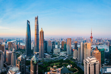 Aerial view of modern city skyline and buildings at sunrise in Shanghai.