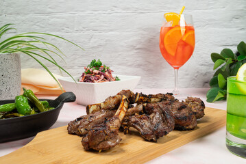 BBQ lamb ribs with shishito peppers, coleslaw and summer cocktails