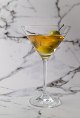 Extra dirty martini served on a marble background 