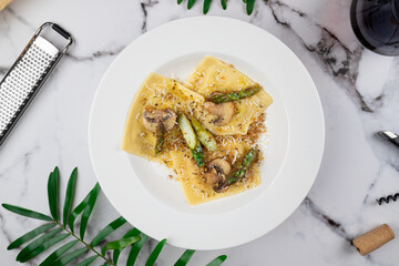 Ravioli in a browned butter lemon sauce with mushrooms, asparagus and seasoned breadcrumbs