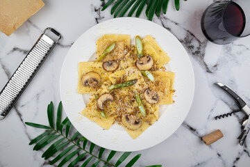 Ravioli in a browned butter lemon sauce with mushrooms, asparagus and seasoned breadcrumbs