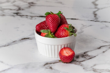Juicy strawberries on a white marble countertop