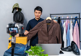 man selling clothes and accessories online by camera live streaming, business online e-commerce at...