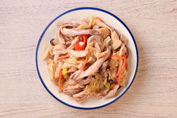 Stir-fried Chinese sauerkraut with pork stomach  on the white plate
