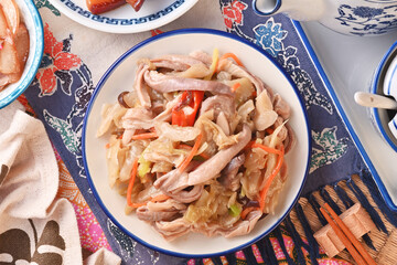 Stir-fried Chinese sauerkraut with pork stomach  on the white plate